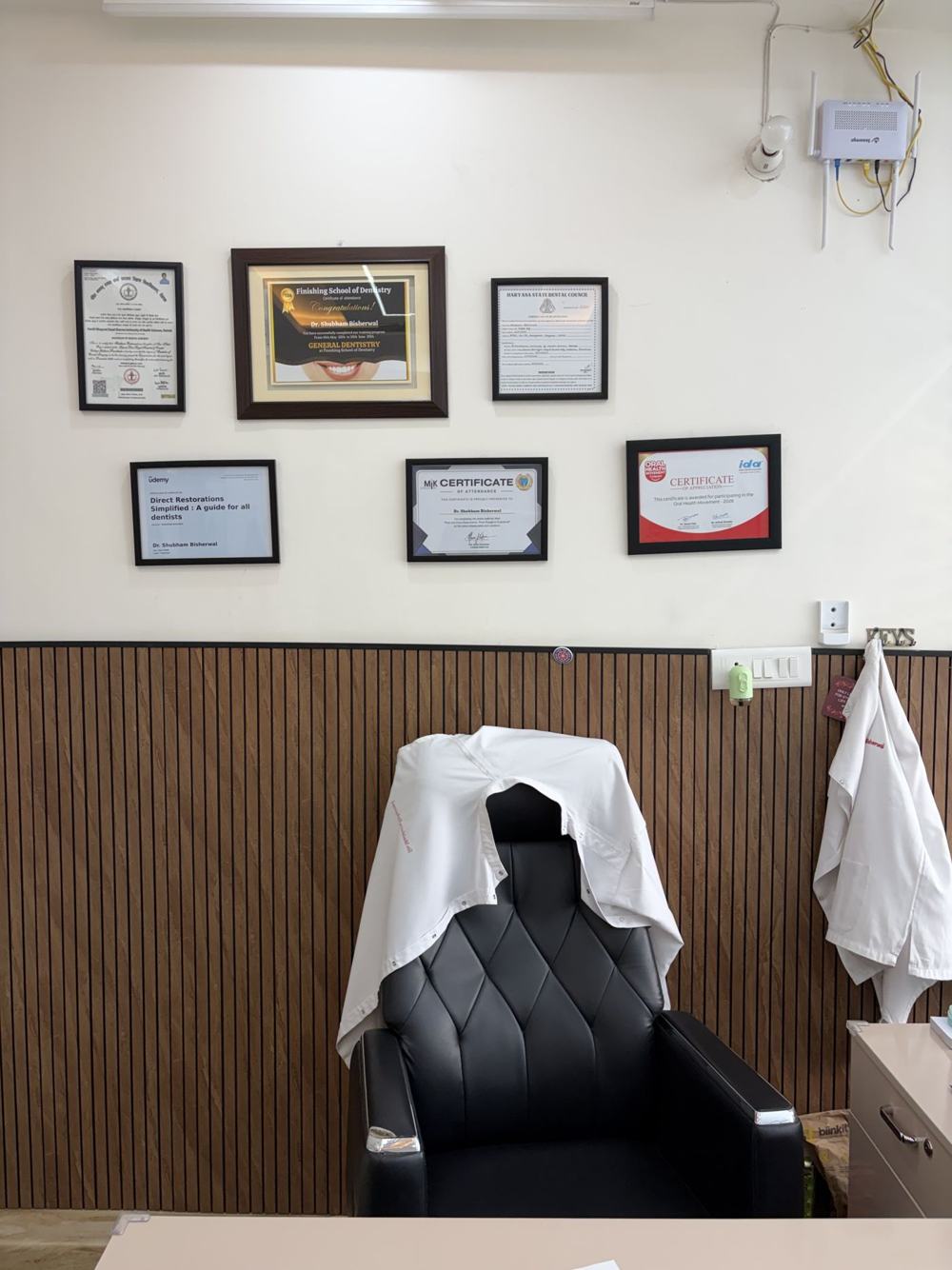 Dr Bisherwal's degree and registration certificates on the wall
