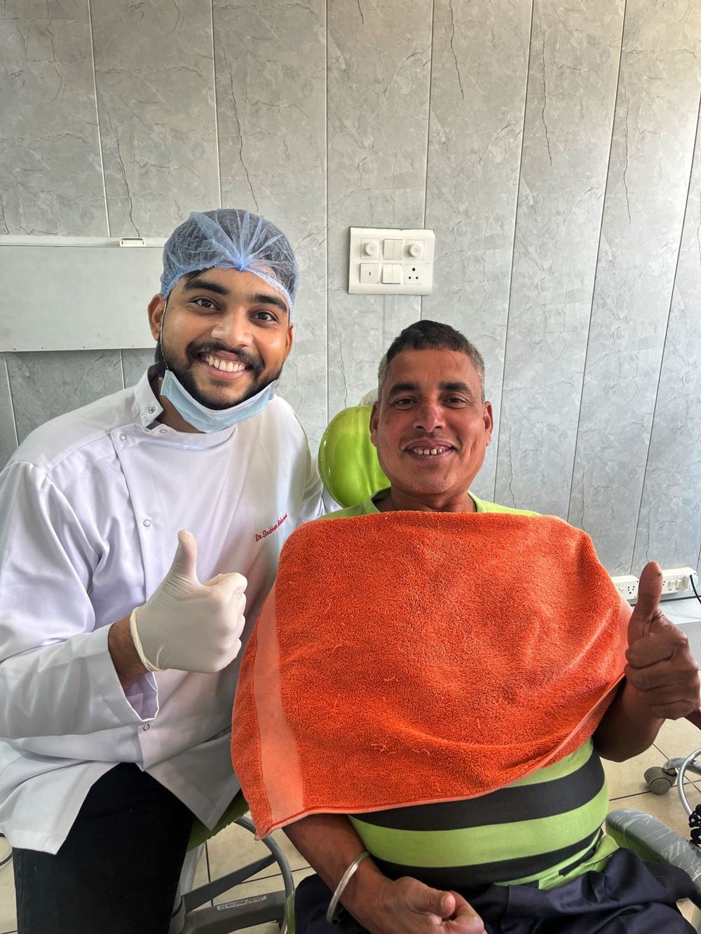 A patient smiling in the dental chair with Dr Shubham Bisherwal